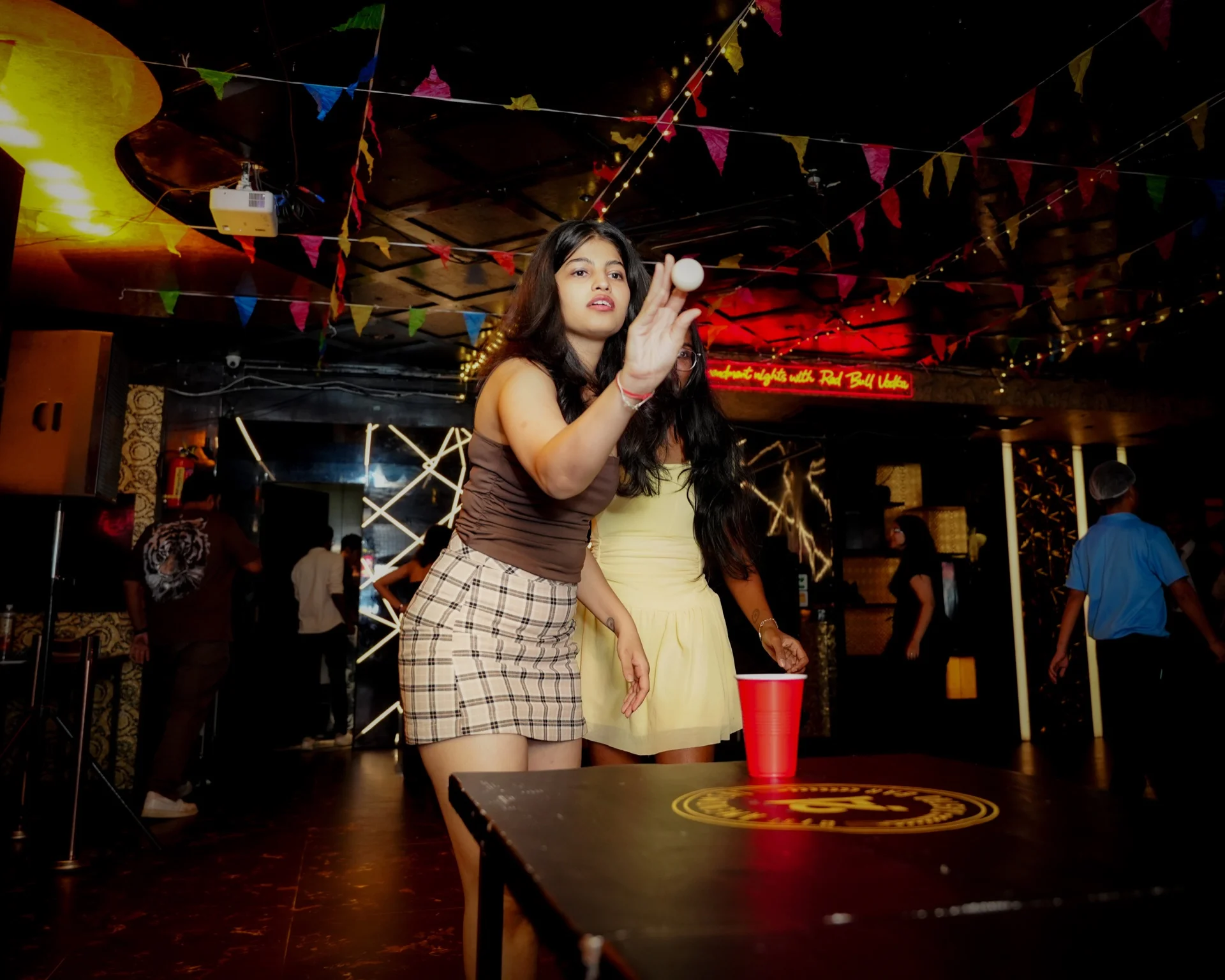 Guest playing beer pong at House Party