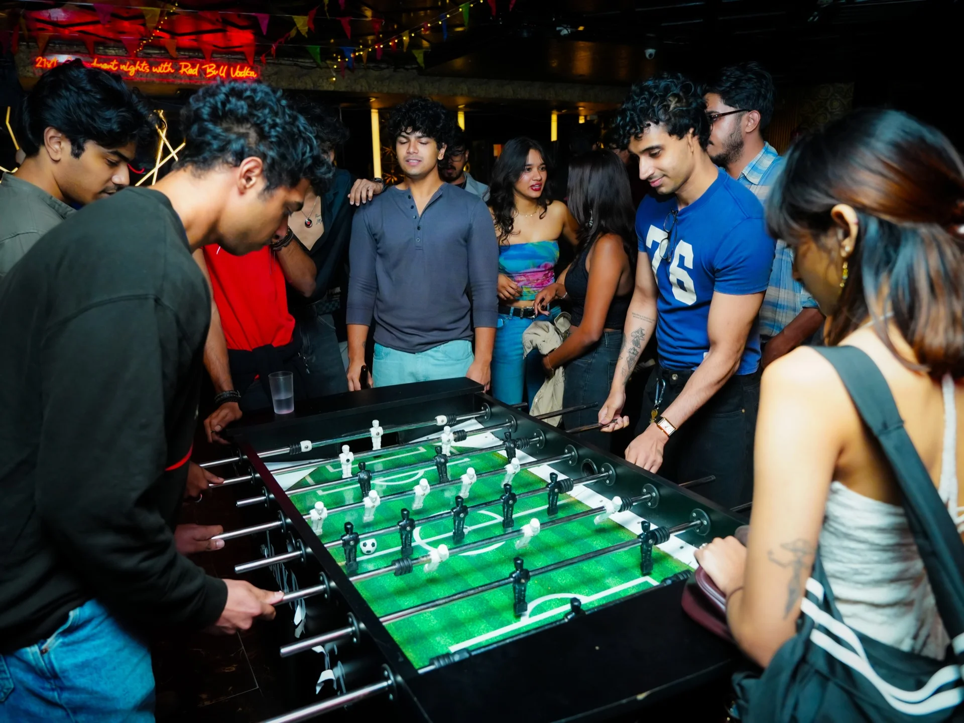 Crowd gathered around the foosball table at House Party