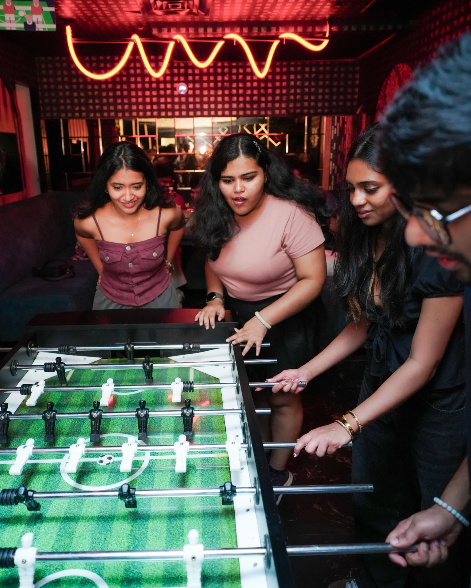 Guests playing foosball at House Party at 21st Amendment