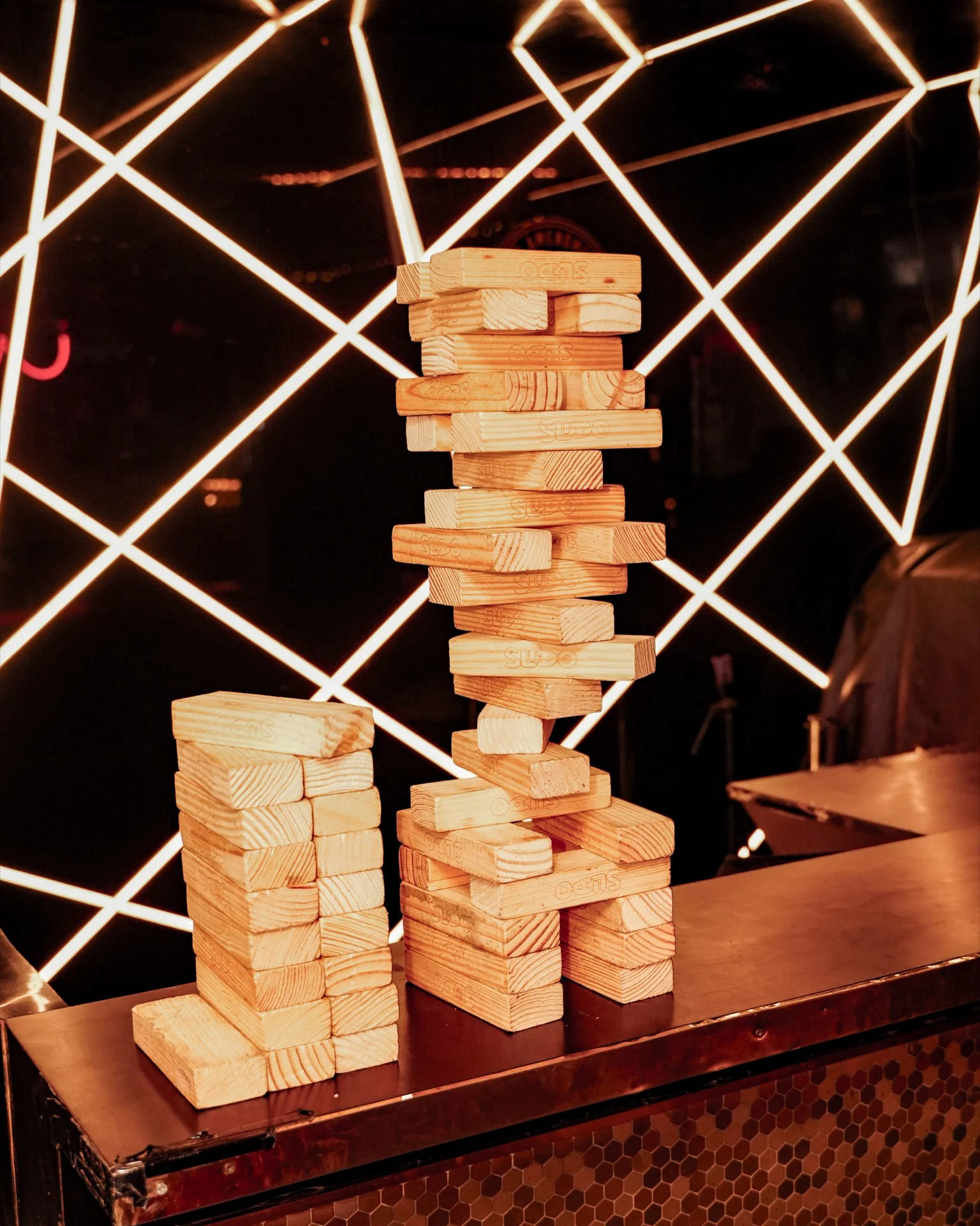 Giant Jenga tower mid-game at House Party