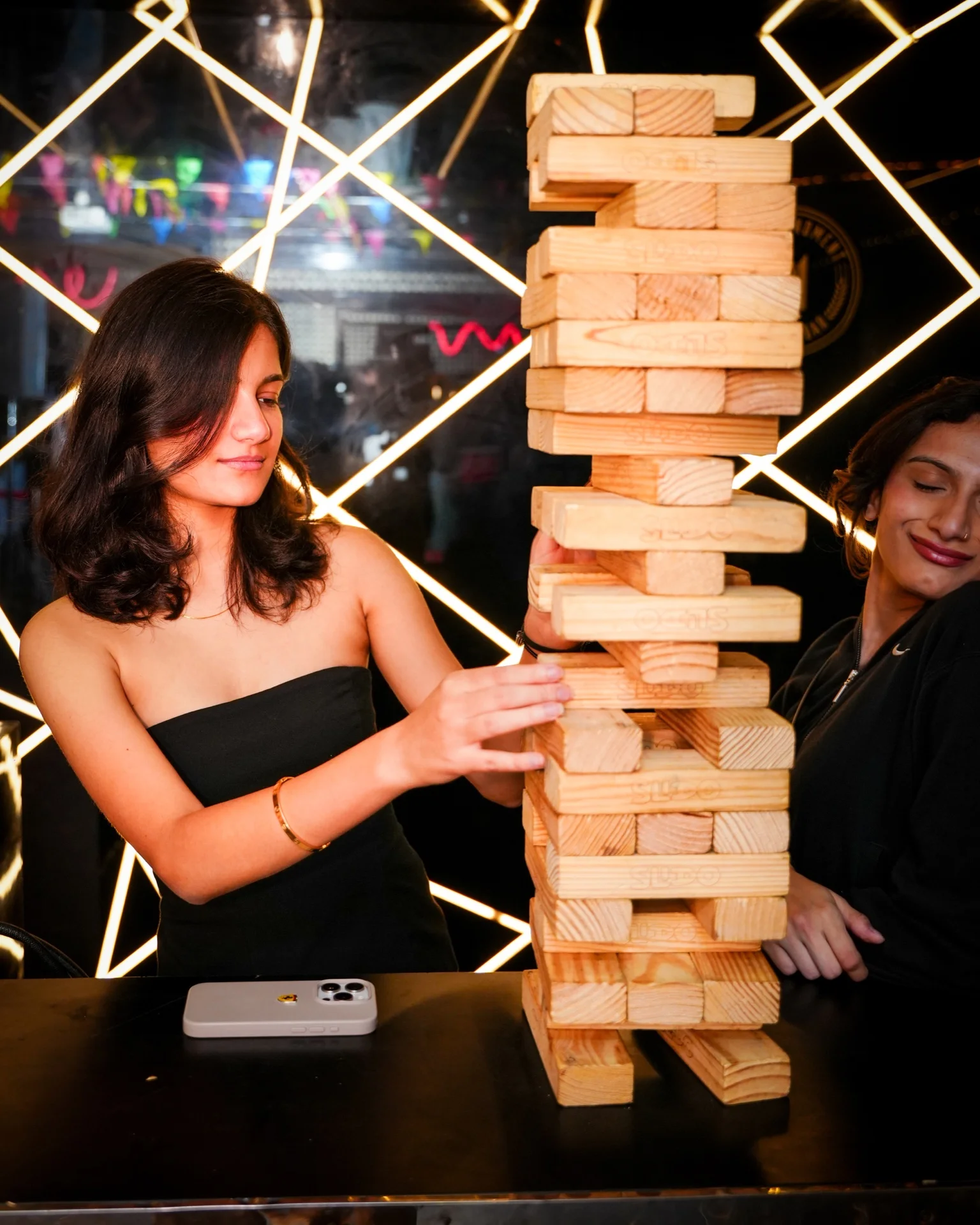Guests playing giant Jenga at House Party